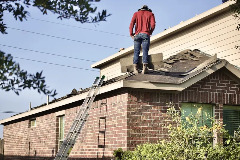 Professional roofer working on a residential roof in Hazardville